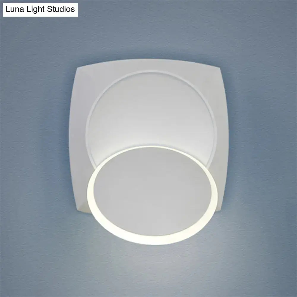 Modern black rotatable led wall sconce featuring a white square frame with circular illuminated ring for bedroom lighting