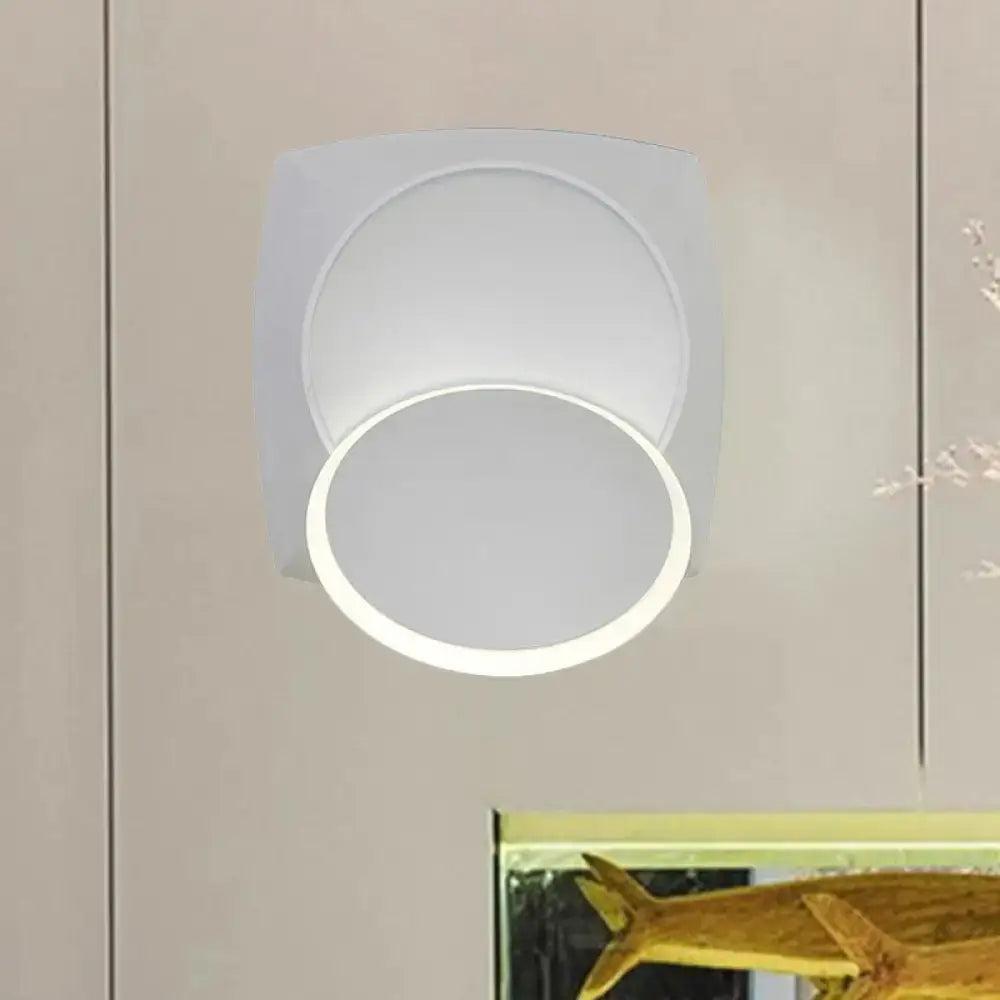 Modern black rotatable led wall sconce with a sleek square frame and white concentric circular led light panels for bedroom use