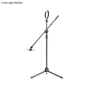 Black metal round led vanity lamp with adjustable arms and tripod base for bedroom use