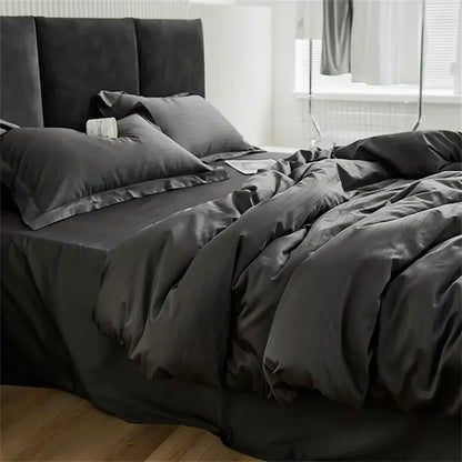 Modern black satin jacquard duvet cover set with matching pillowcases featuring a smooth glossy finish and elegant drape