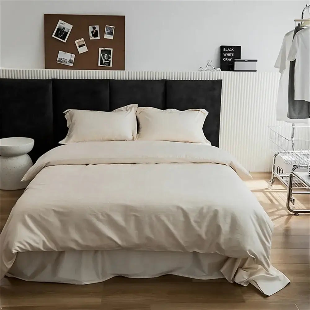 Modern black satin jacquard duvet cover set with cream-colored satin cover set and soft flowing ruffle at the bottom