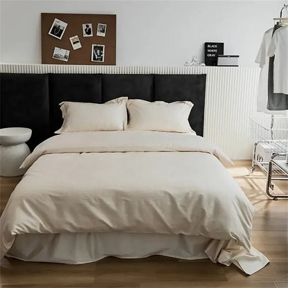 Modern black satin jacquard duvet cover set with cream-colored satin cover set and soft flowing ruffle at the bottom