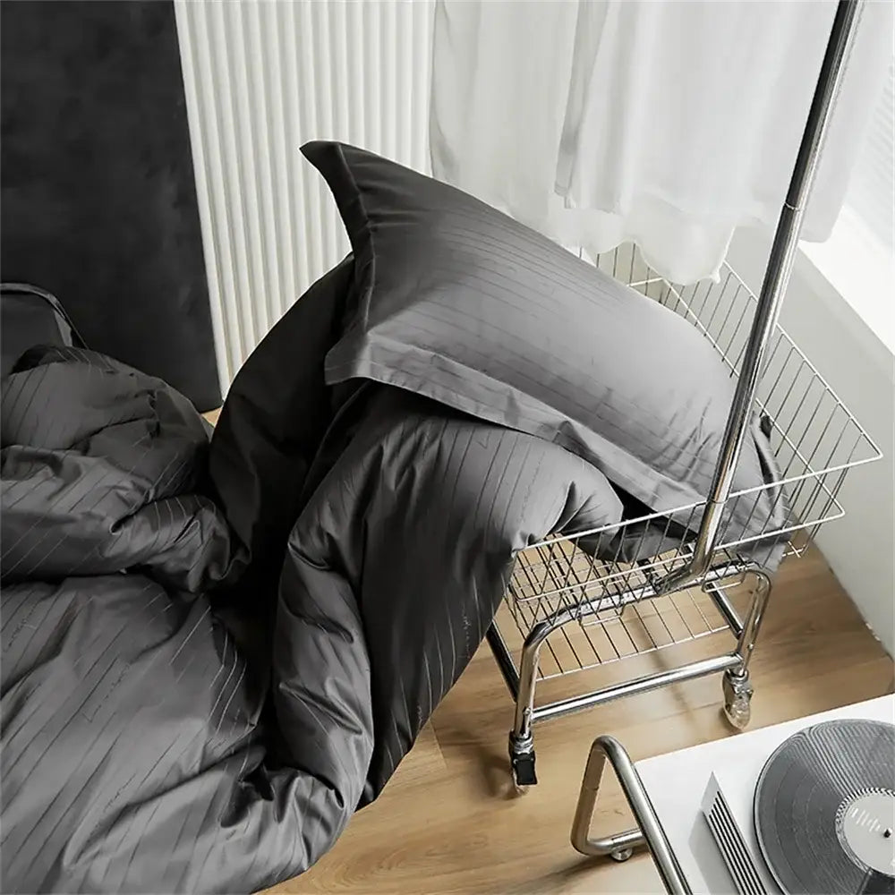 Modern black satin jacquard duvet cover set with dark gray striped duvet cover and pillow set in a wire shopping cart