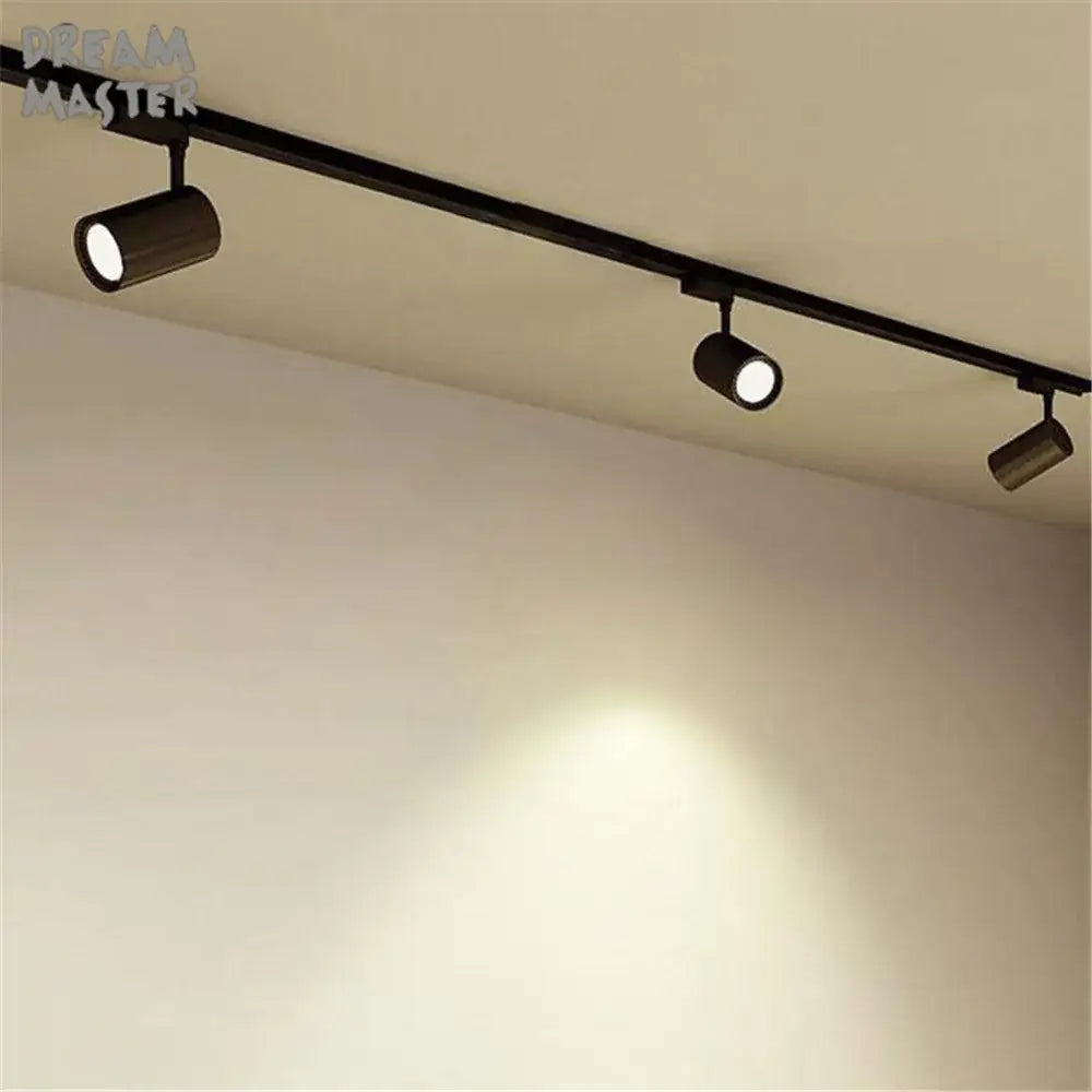Modern black and silver ceiling track rail connector set with black cylindrical decorbites ceiling track lighting fixtures