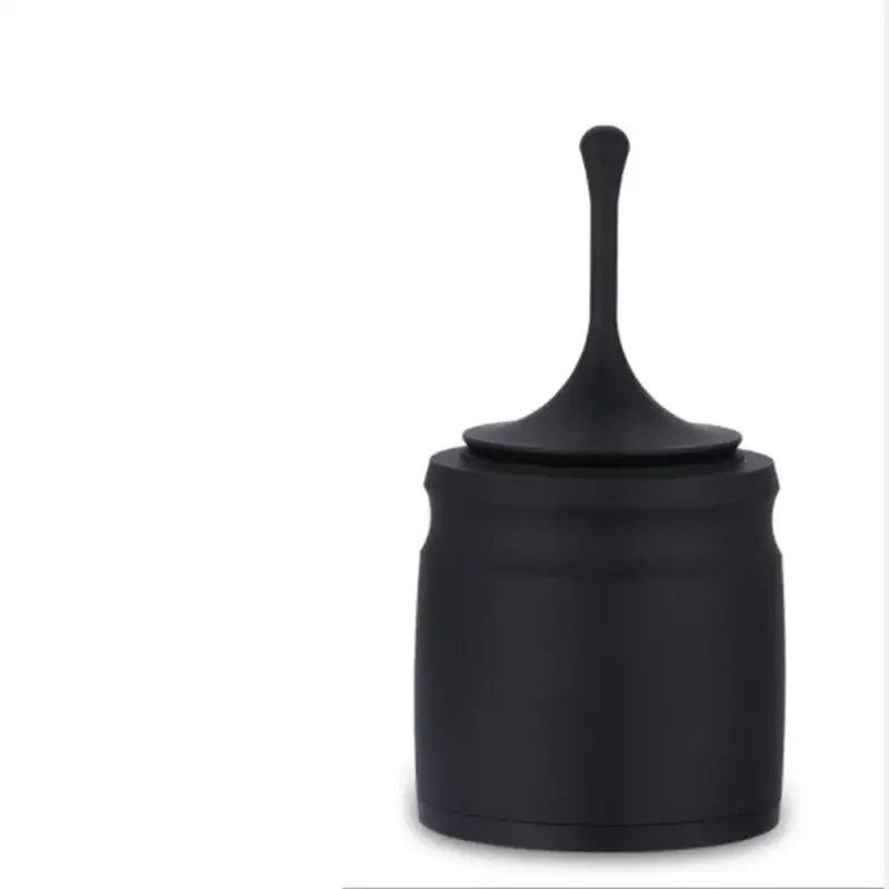 Modern black and silver coffee tamper bowl with dosing ring featuring a sleek tapered lid and smooth matte finish