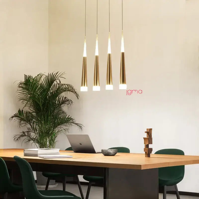 Four sleek gold-toned pendant lights with tapered conical tube shades from decorbites for kitchen island decor