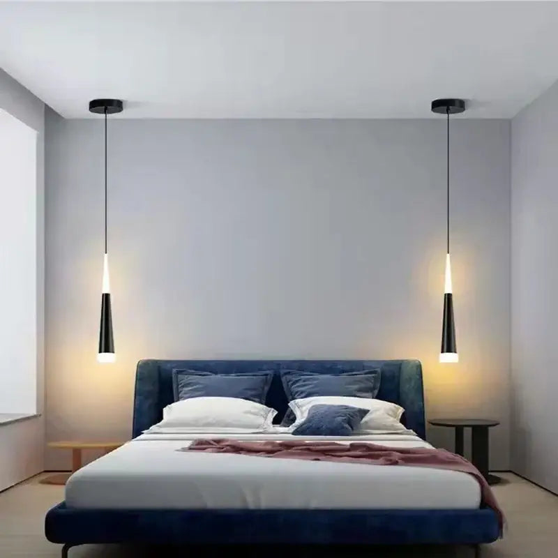 Modern black and silver conical tube pendant lights with sleek tapered design hang symmetrically above the bed decorbites conical tube