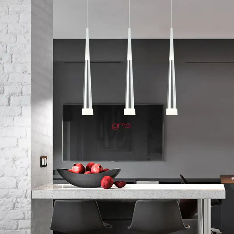 Three modern black and silver conical tube pendant lights by decorbites hang over a kitchen island