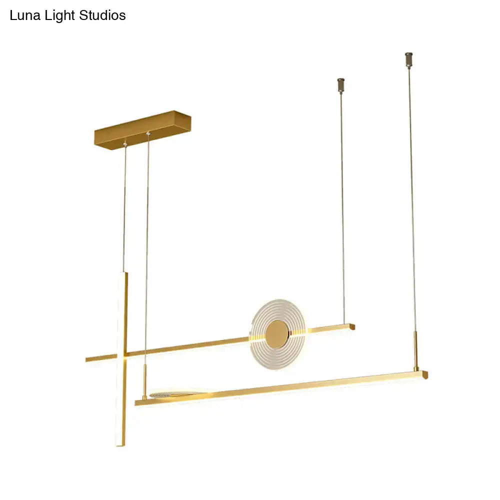 Modern gold-toned geometric pendant light fixture with circular acrylic rings designed as a dining room island chandelier