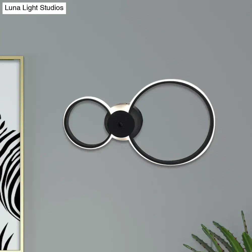 Modern black and silver led hoop wall lamp with sleek minimalist circular design for bedroom ceiling lighting
