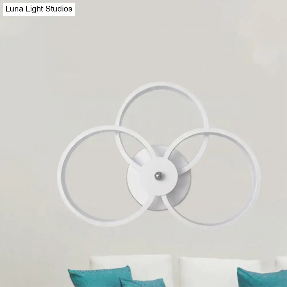 Modern white circular wall lamp with three interlocking rings features a LED hoop design for bedroom ceiling lighting