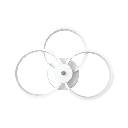 White modern ceiling light fixture with three interlocking rings designed as a wall lamp for bedroom use