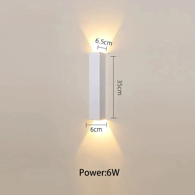 Modern black and silver led wall lamp with white rectangular wall sconce and warm dual-directional light sources for bedroom