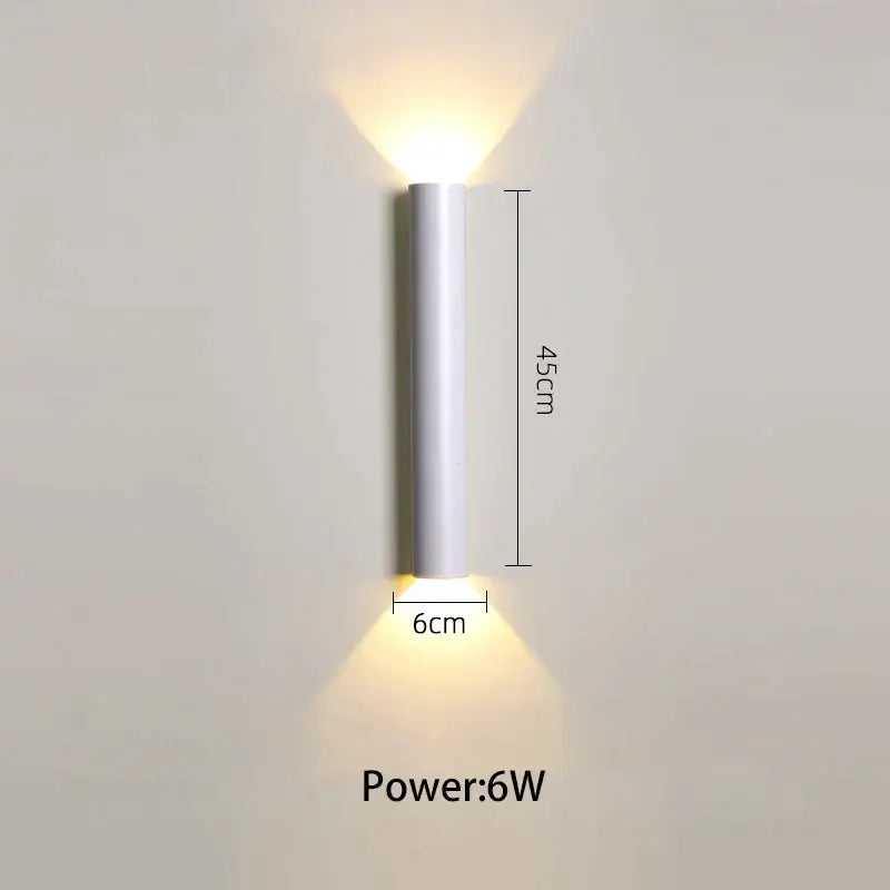 A sleek 45cm tall white cylindrical led wall lamp with warm up and down light for modern bedroom use