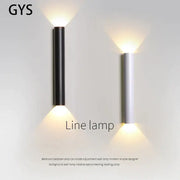 Modern black and silver led wall lamp with cylindrical design providing warm up and down light sources for bedrooms