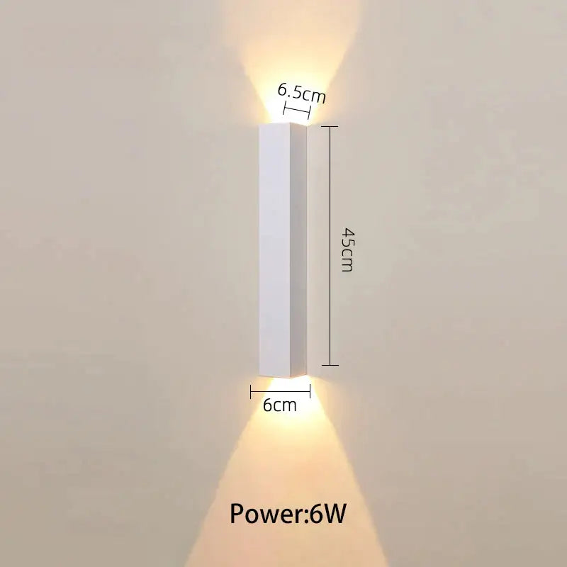 Modern black and silver led wall lamp with white rectangular fixture and warm up and down light sources for bedroom