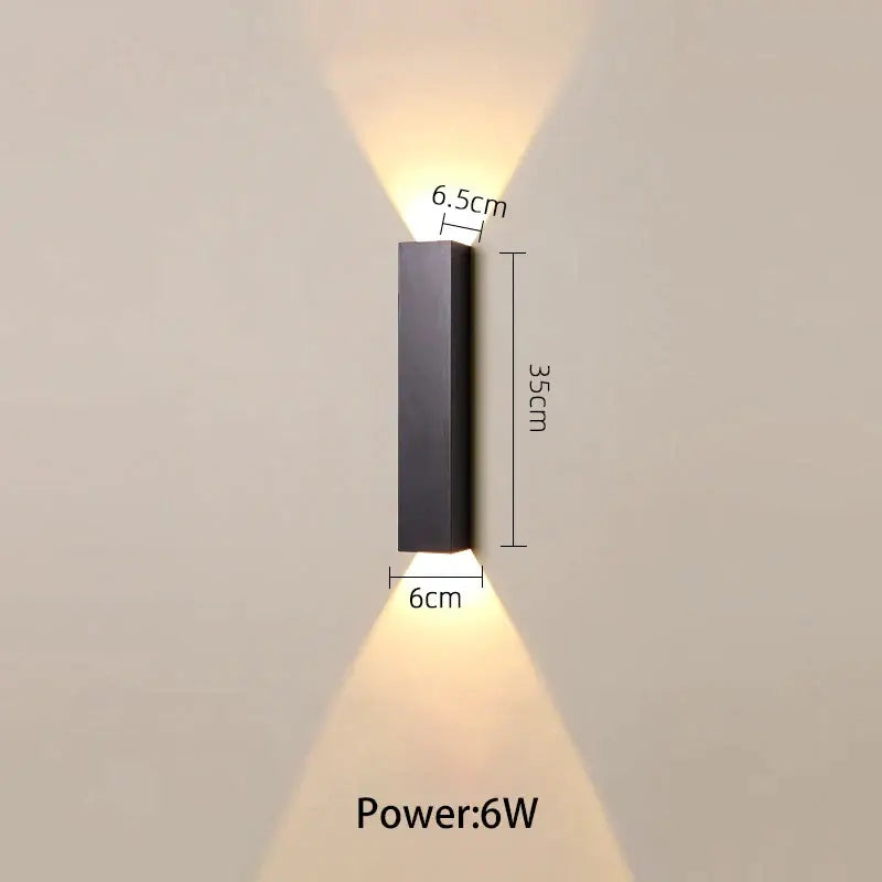 Modern black and silver led wall lamp with rectangular minimalist design emitting warm up and down light source