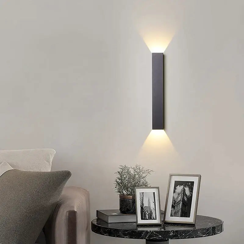 Modern black and silver led wall lamp with rectangular design and warm up and down light beams for bedroom use