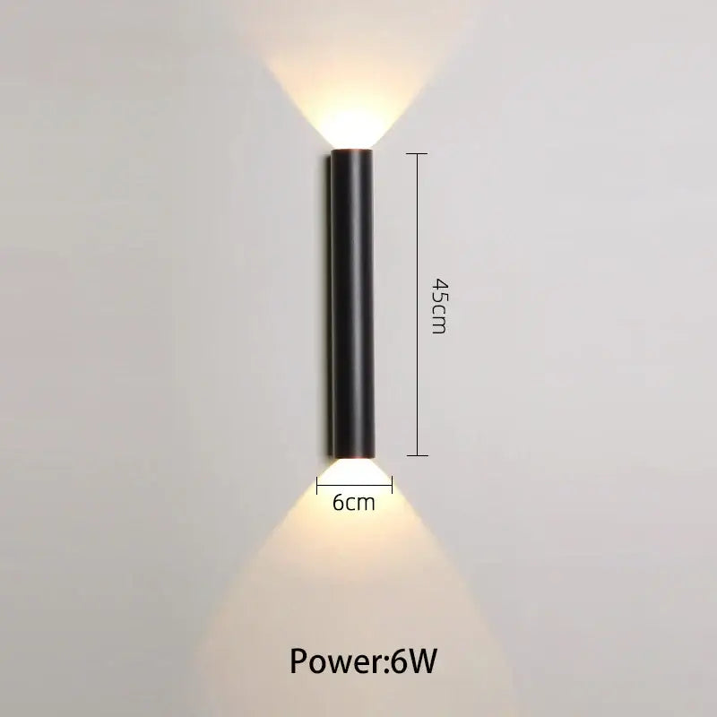 Modern black and silver led wall lamp with cylindrical design and two warm white downward beams for bedroom or tv background