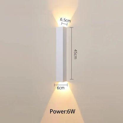 A sleek minimalist white led wall lamp with slim rectangular design and warm light for bedroom or tv background