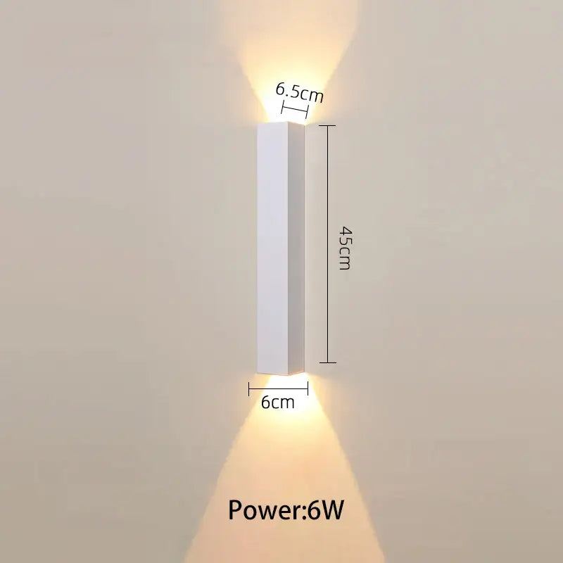A sleek minimalist white led wall lamp with slim rectangular design and warm light for bedroom or tv background