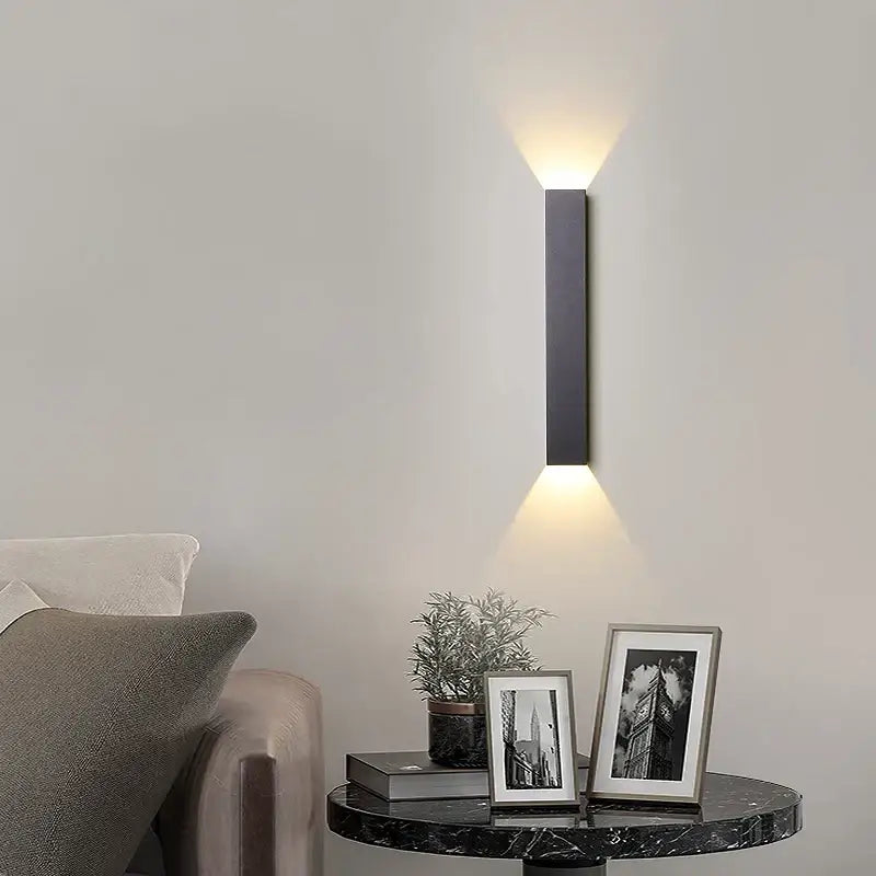 Modern black and silver led wall lamp with two warm downward lights for bedroom or tv background lighting