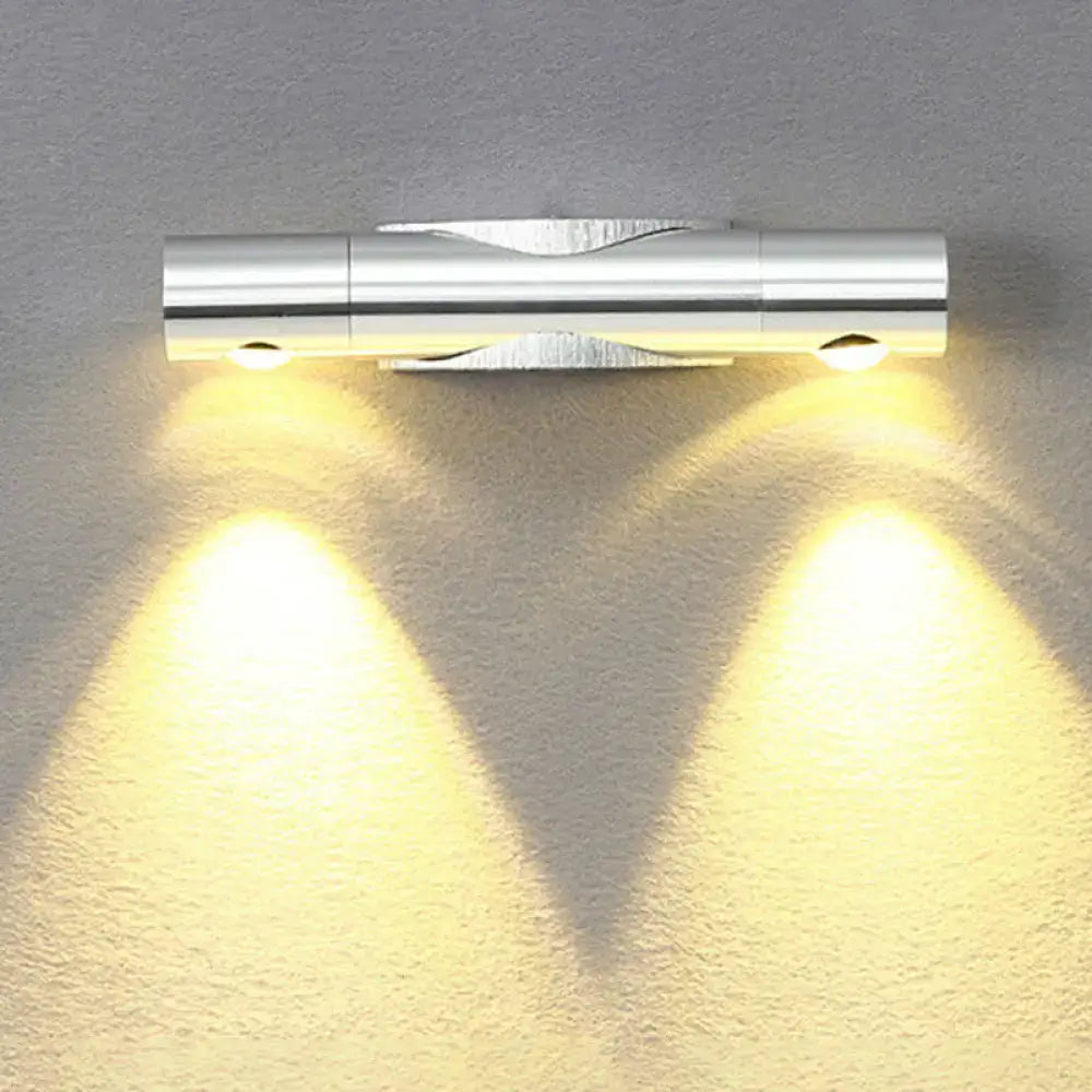 Silver metallic wall sconce light fixture with warm white lighting perfect for modern living room decor