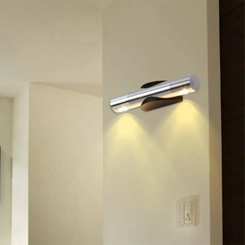 Modern chrome-finished light fixture with sleek cylindrical design providing warm white lighting for living room
