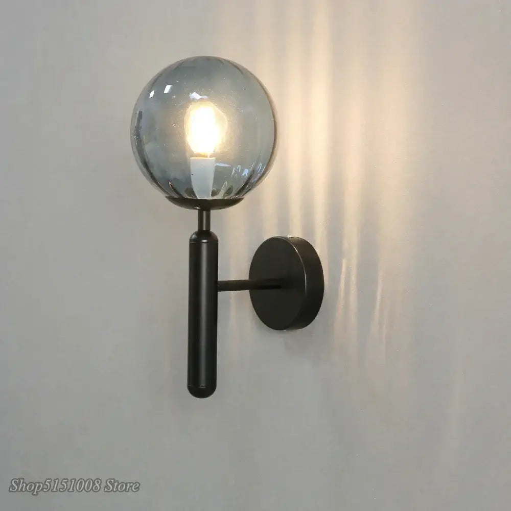 Modern black metal wall lamp with a frosted glass ball led globe ideal for bedroom sconce decorbites glass ball lighting