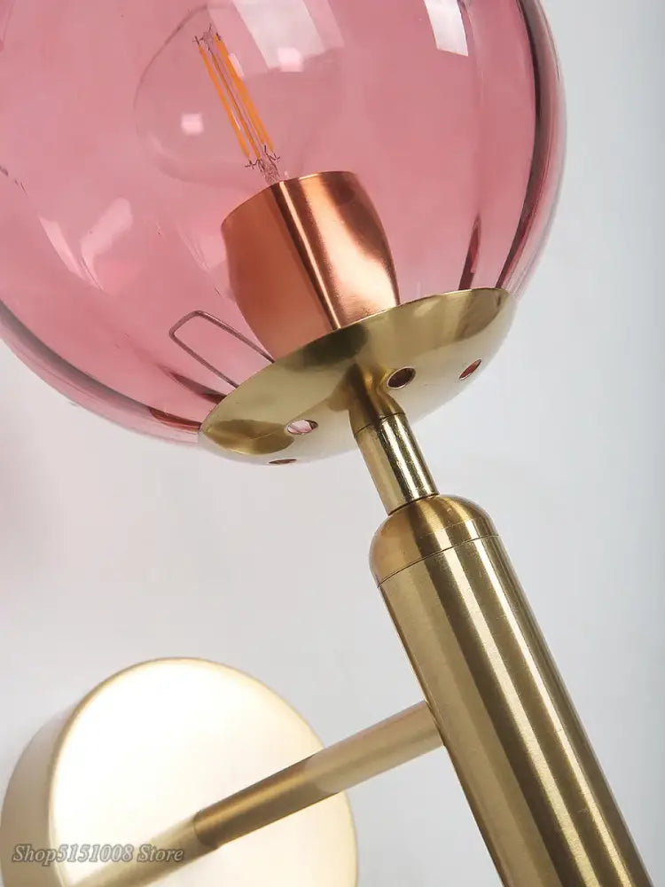 Modern wall lamp with pink glass ball led shade and brass base perfect for bedroom decorbites glass ball sconce