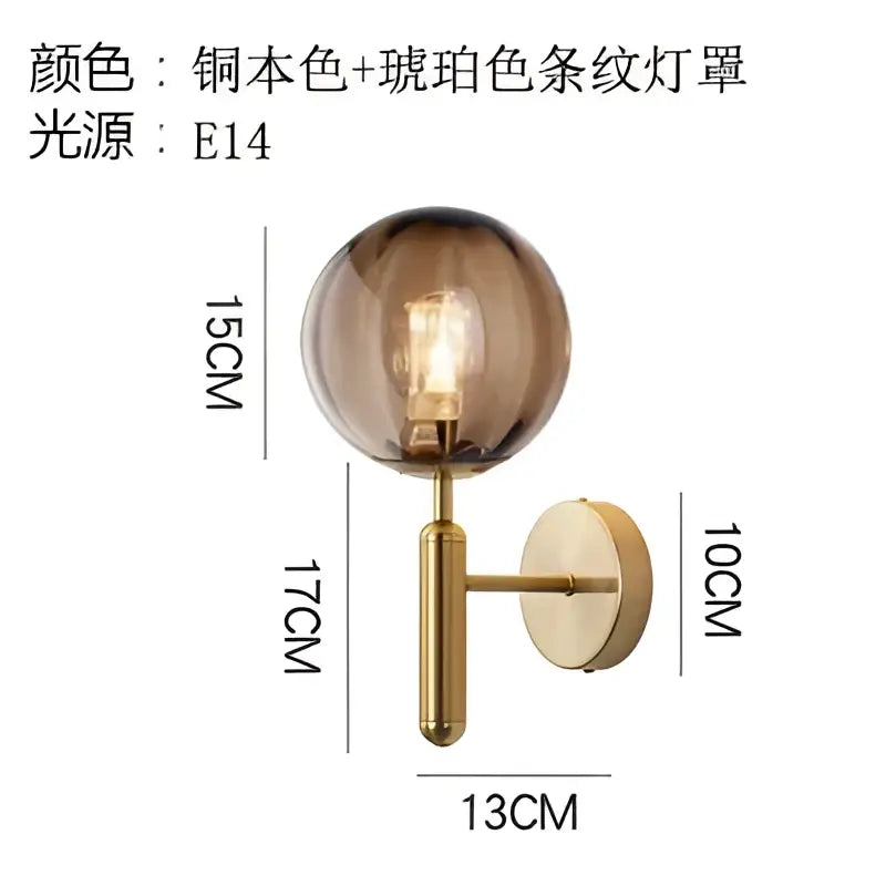 A spherical amber glass ball led wall lamp with brass-finished base designed as an elegant decorbites glass ball sconce