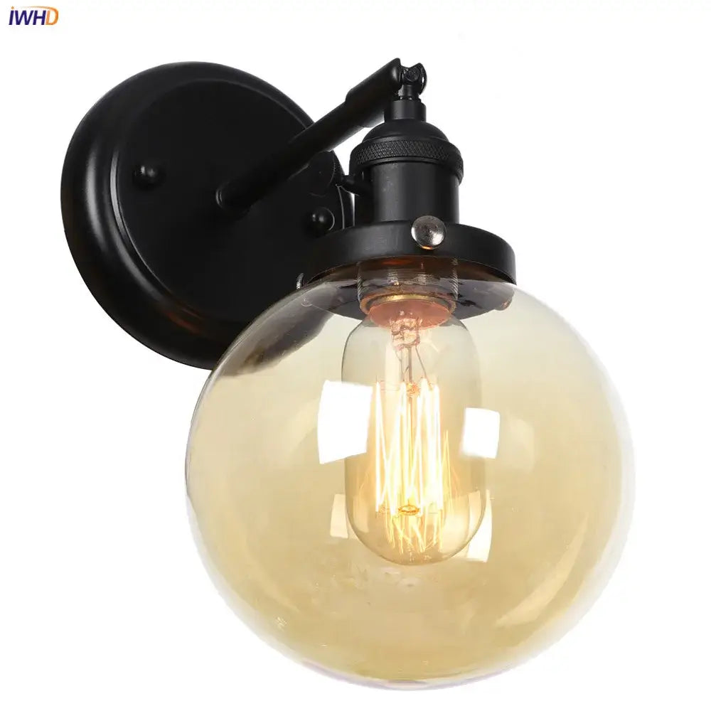 Modern black wrought iron wall sconce with a smoked amber glass ball and exposed filament bulb for hallway decorbites glass ball wall