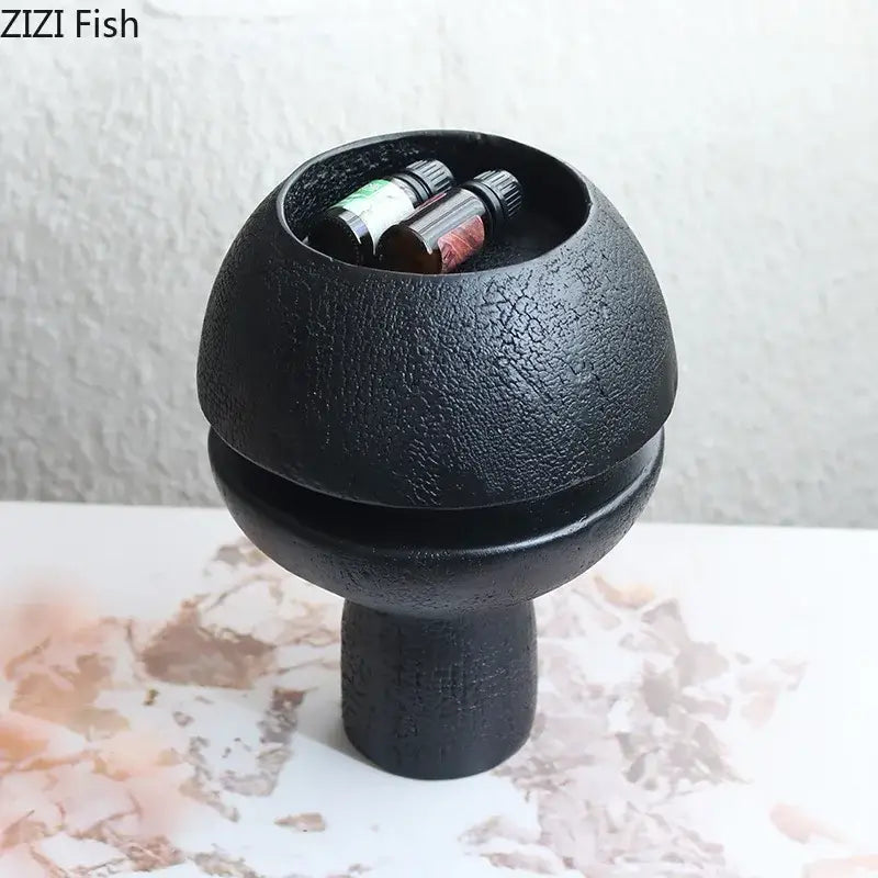 Modern black spherical resin sculpture with black textured ceramic incense burner bowl and pedestal base decorbites black spherical