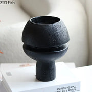 Modern black spherical resin sculpture featuring a black textured ceramic vase with a rounded two-tiered design for decorbites black spherical decor