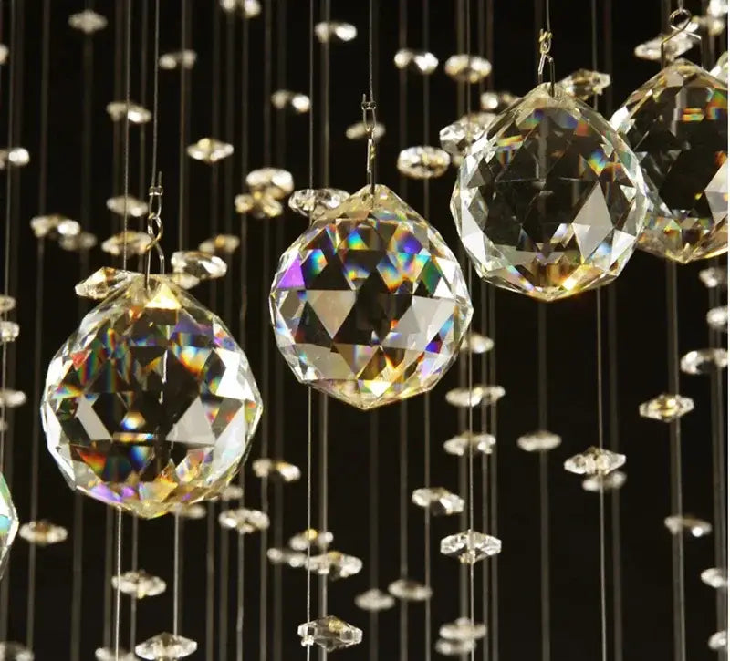Modern black spiral decorbites crystal pendant chandelier with clear faceted crystal spheres hanging against dark background