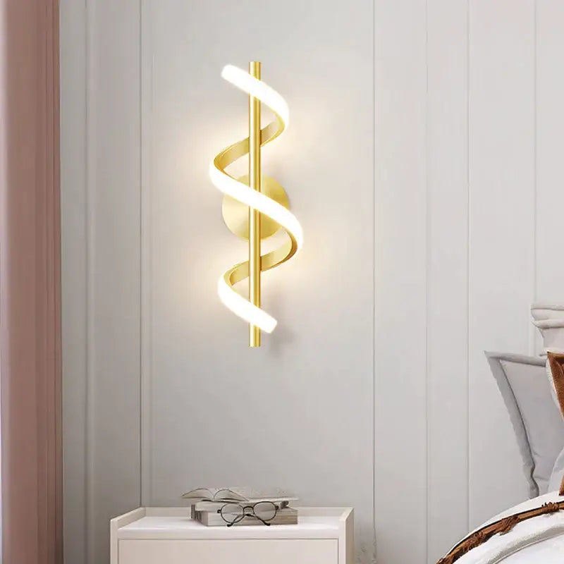Modern gold-colored spiral led wall lamp with sleek design and warm lighting for bedroom use