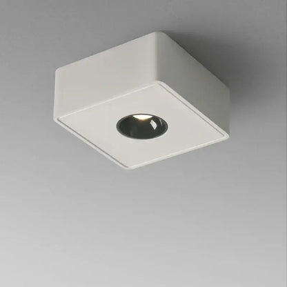 Modern black square led ceiling light with white surface and black circular center emitting warm illumination decorbites 12w