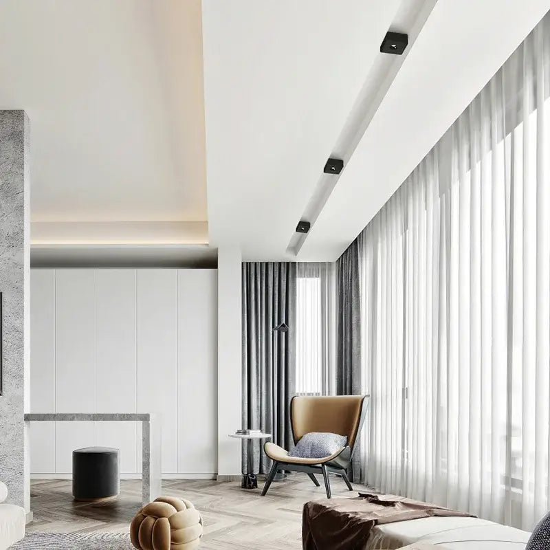 A modern tan leather armchair with sleek curved design and black metal legs next to a decorbites led surface mount ceiling light