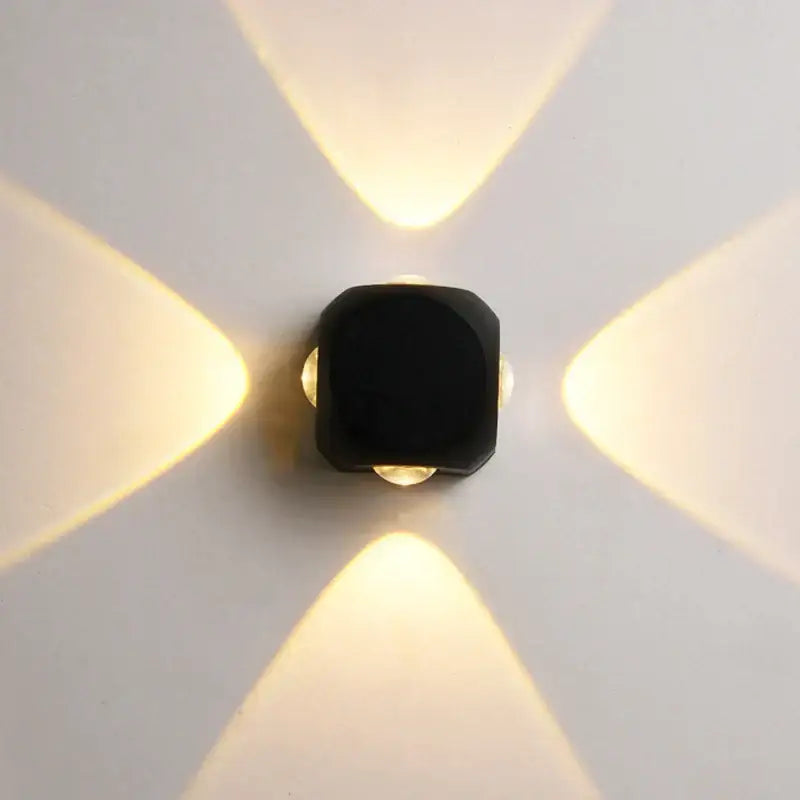 Modern black square led wall light with four warm-toned beams for outdoor garden wall light decor