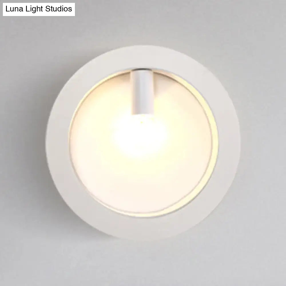 Modern black square wall sconce lamp with white circular frosted glass light and warm ambient glow for bathroom use
