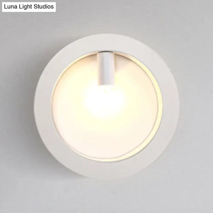 Modern black square wall sconce lamp with white circular frosted glass light and warm ambient glow for bathroom use