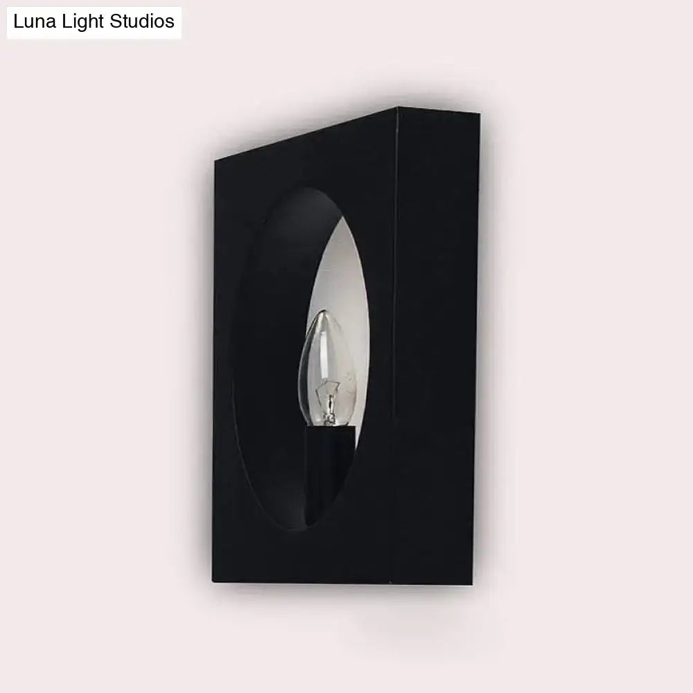 Modern black square wall sconce lamp with frosted glass and oval cutout framing bulb for bathroom lighting