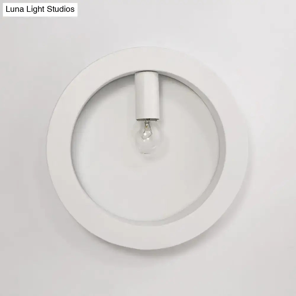 Modern black square wall sconce lamp with white circular frosted glass light fixture and central bulb for bathroom use