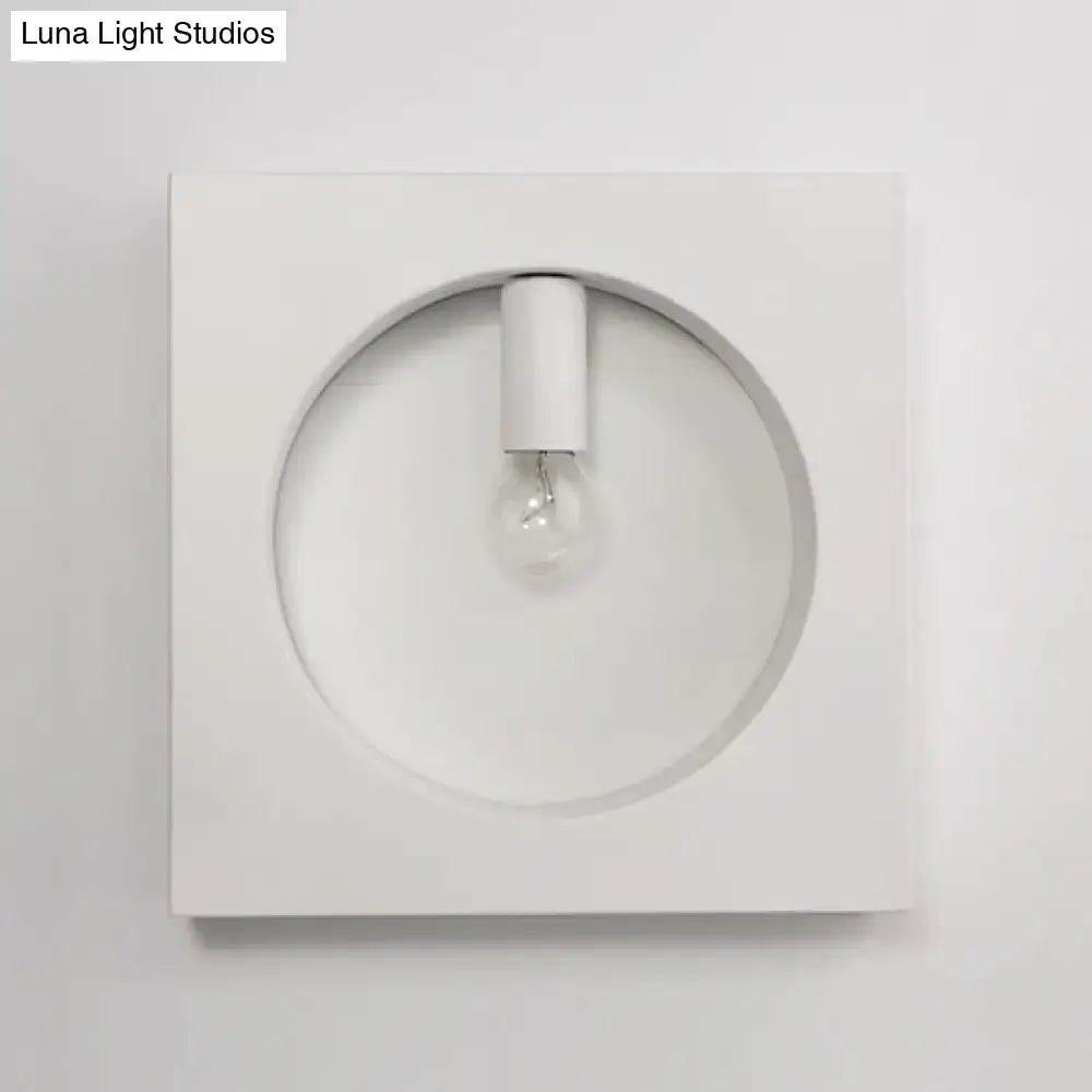 Minimalist white wall sconce lamp with circular recess and exposed bulb designed for modern bathroom lighting
