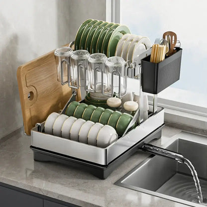 Modern black stainless steel 2 tier dish drainer rack with tiered compartments holding plates bowls glassware and utensils