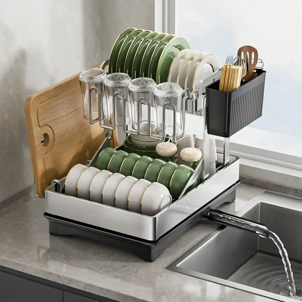 Modern black stainless steel 2 tier dish drainer rack holding green and white plates glassware and utensils
