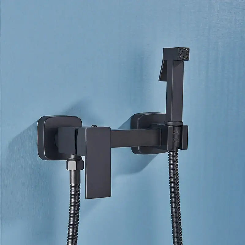 Modern black matte-finished brass bidet faucet with stainless steel sprayer and flexible hose for bathroom use