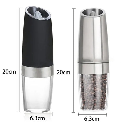 Modern black and stainless steel electric salt pepper grinder with clear base showing peppercorns inside for kitchen use