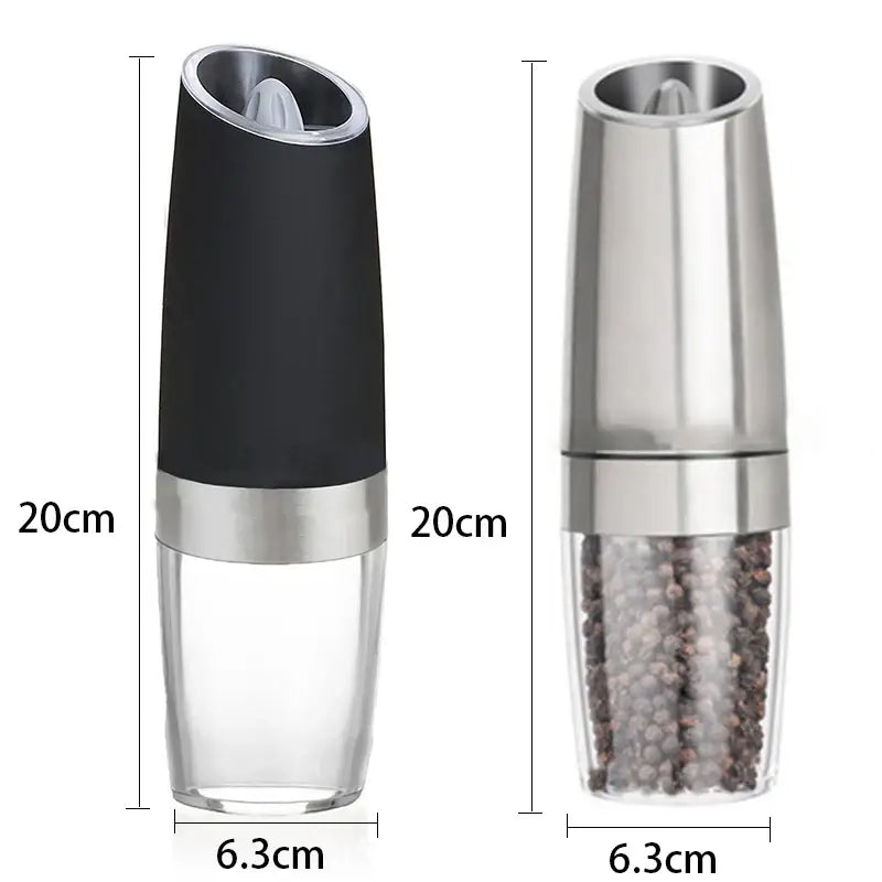 Modern black and stainless steel electric salt pepper grinder with clear base showing peppercorns inside for kitchen use
