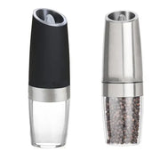 Modern black and stainless steel electric salt pepper grinder with clear base containing peppercorns for kitchen use